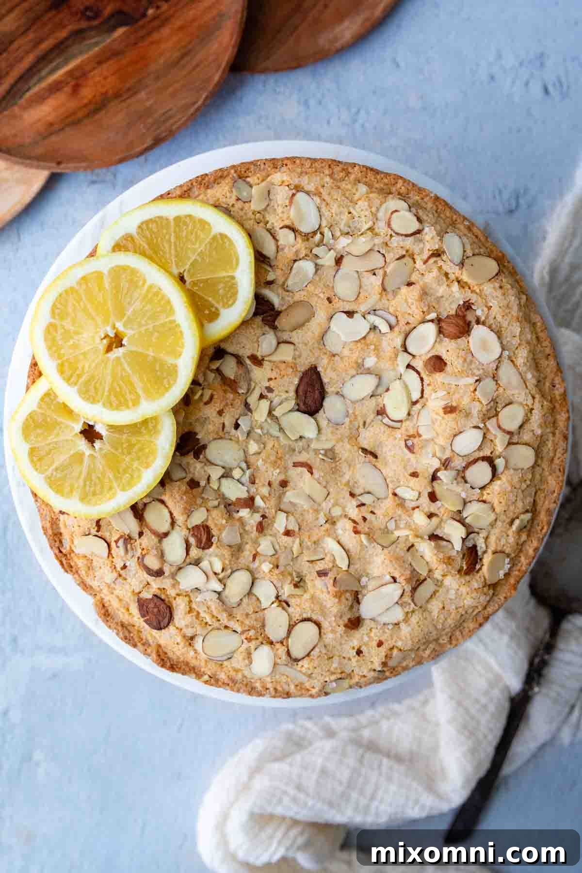 top view of baked cake with lemons arranged around the edge.