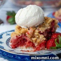 A slice of gluten-free strawberry pie with ice cream on top and a bite taken out.