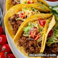 A plate of delicious gluten-free ground beef tacos, garnished and ready to be enjoyed.