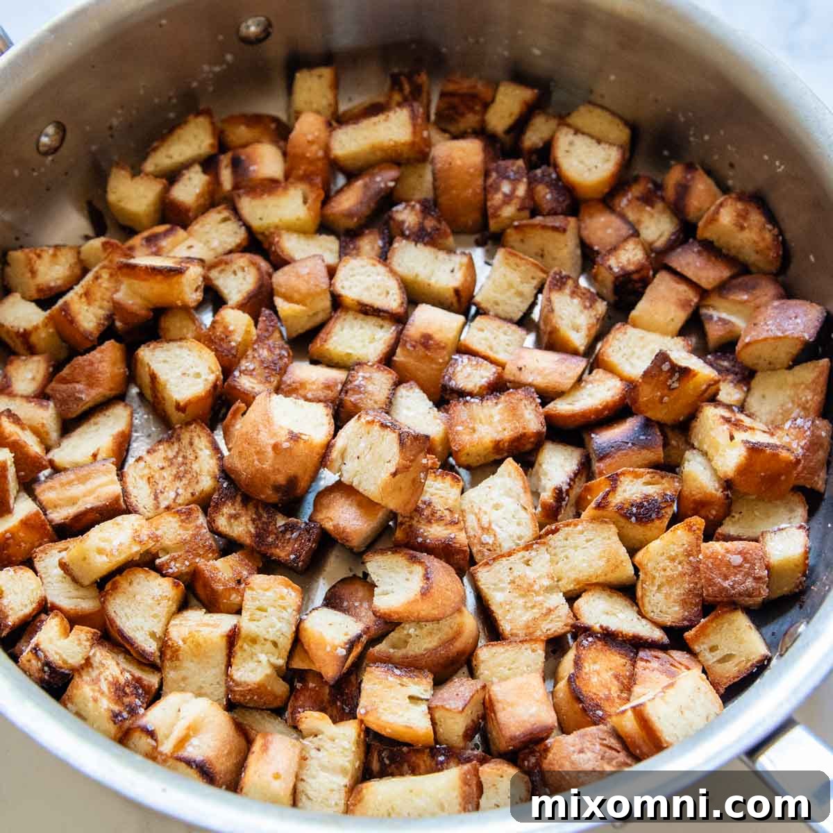 bread cubes toasted in a skillet.