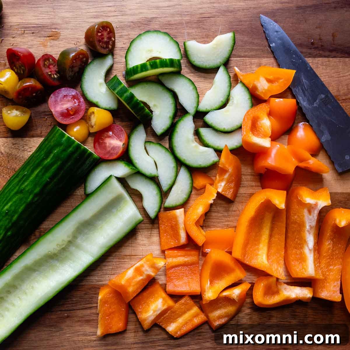veggies chopped up on a wooden cutting board.