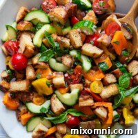 overhead shot of panzanella in a white serving bowl.