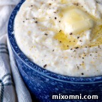 A close-up of butter melting on a bowl of grits, indicating a perfectly creamy and delicious dish.