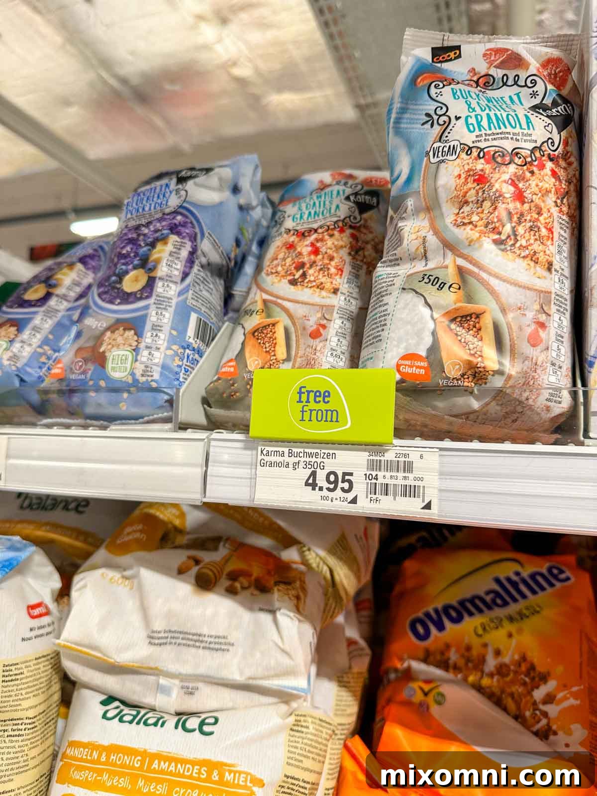 A close-up view of a supermarket aisle in Switzerland, displaying a diverse array of gluten-free grocery items like crackers, cookies, and packaged meals, all clearly labeled for celiac travelers.