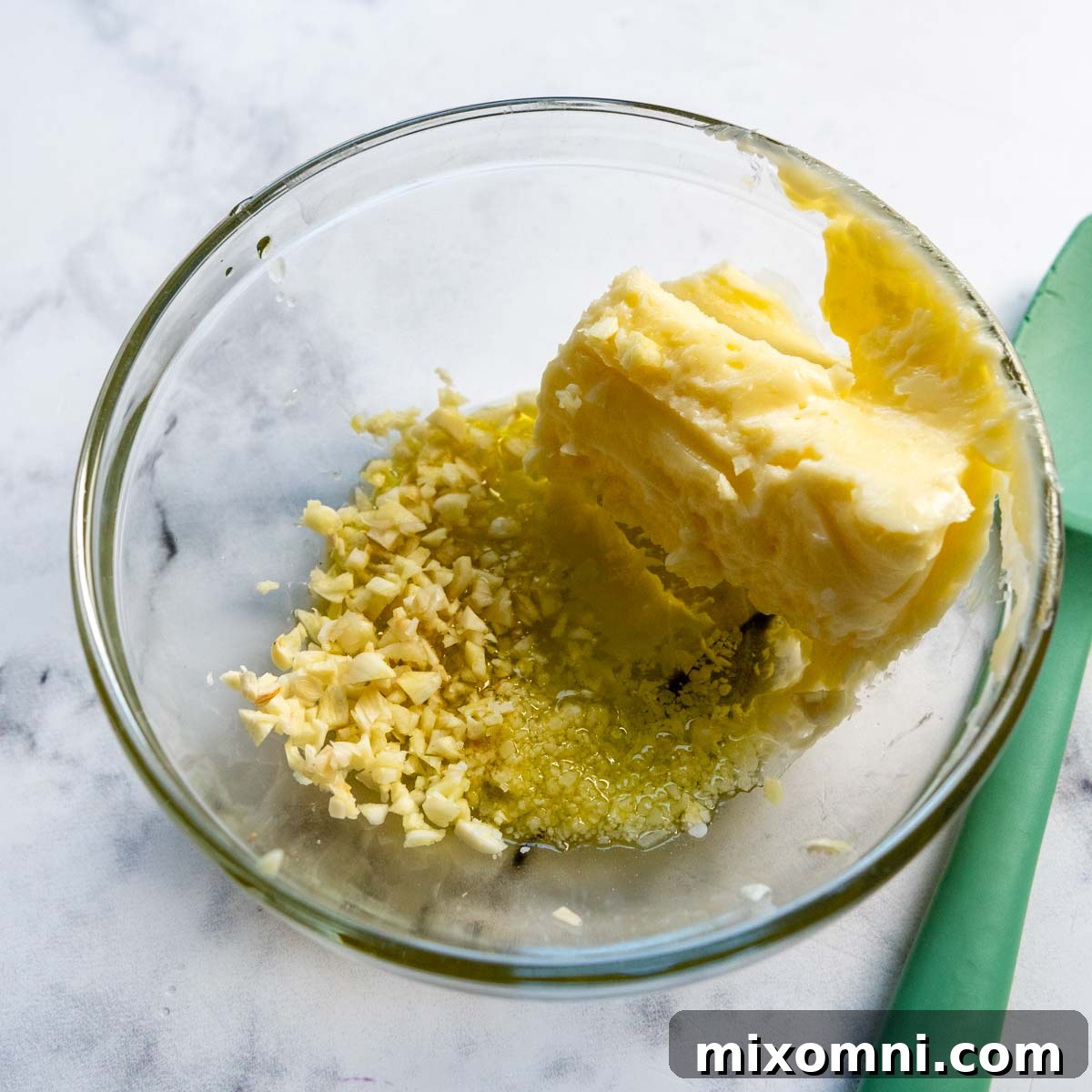 Gluten-free crostini slices covered with garlic butter, arranged on a baking sheet before entering the oven.
