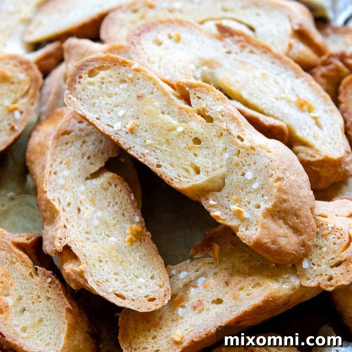 a stack of crostini toast with salt sprinkled on.
