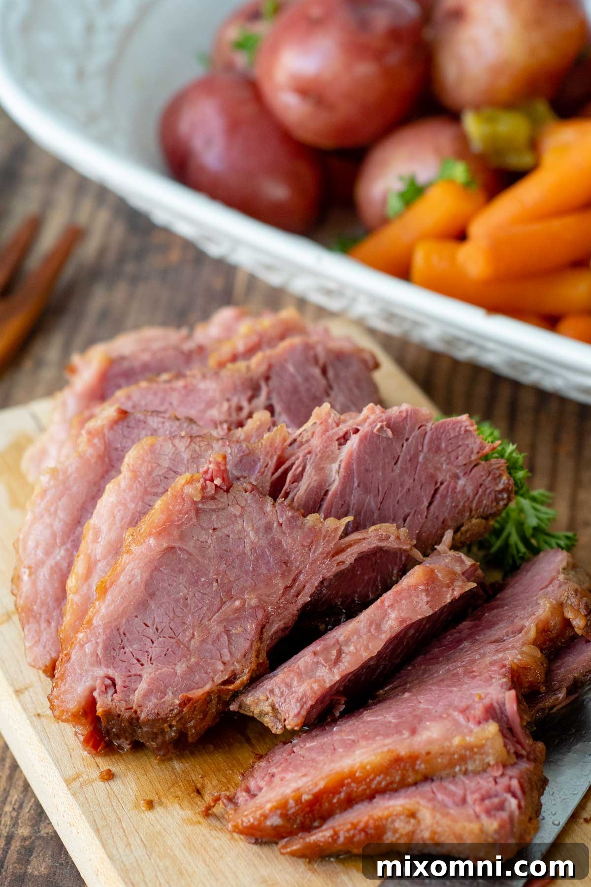 Perfectly sliced corned beef resting on a wooden cutting board, showcasing its tender texture.