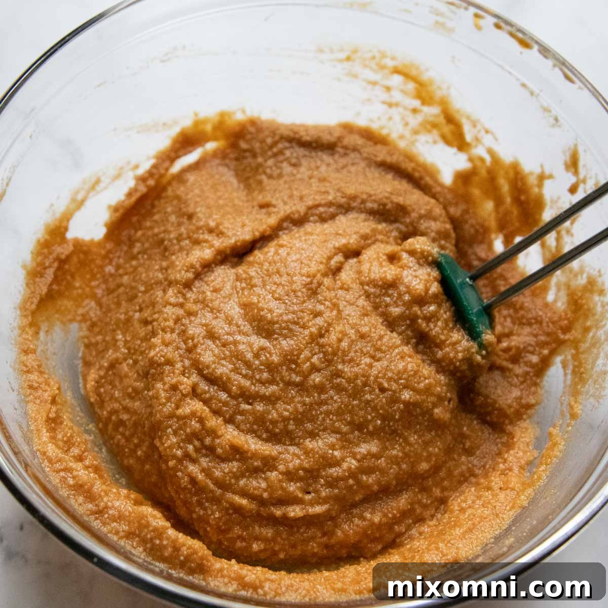 Bread batter being mixed in a bowl.