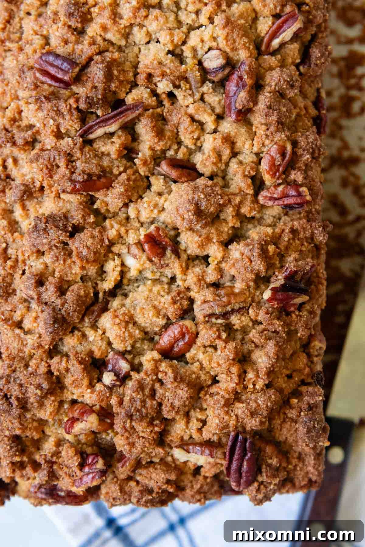 Close-up showing the textured top of the baked almond flour pumpkin bread with streusel.