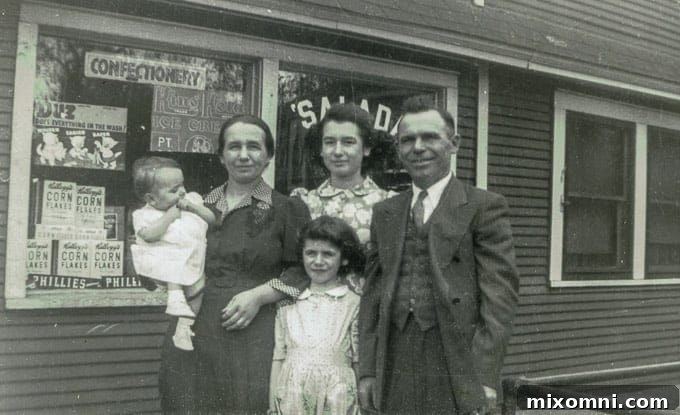 My mother as a baby, flanked by her sisters and parents, proudly standing before their family grocery store in Gary, Indiana.