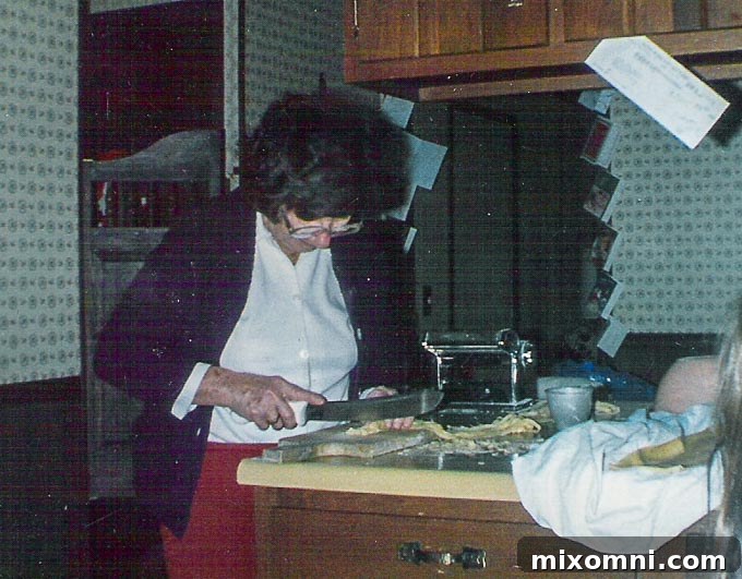 Gramma skillfully preparing fresh, homemade pasta in our family kitchen, a cherished tradition.