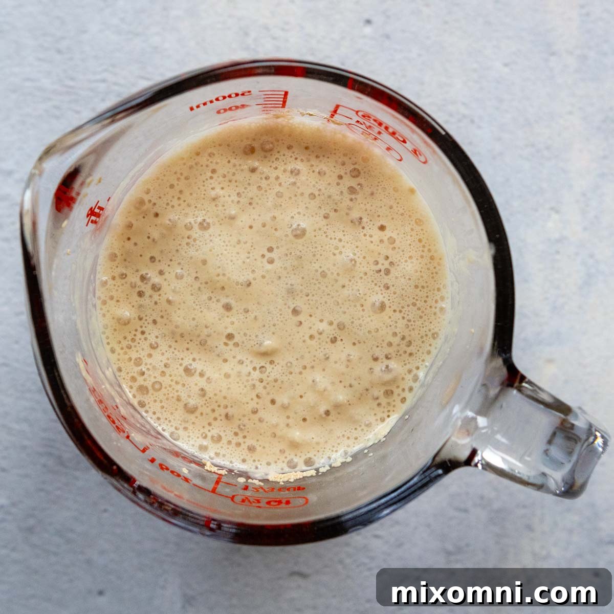 yeast / water ingredients in a glass measuring cup.