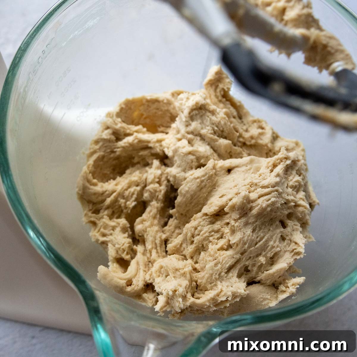 dough in a glass bowl having just been mixed.