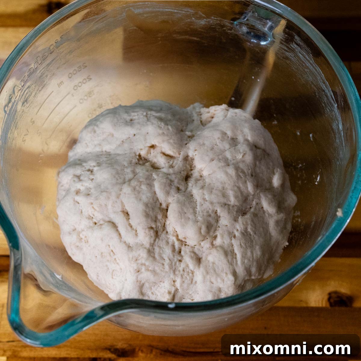 pretzel dough resting in a glass bowl. after rising.
