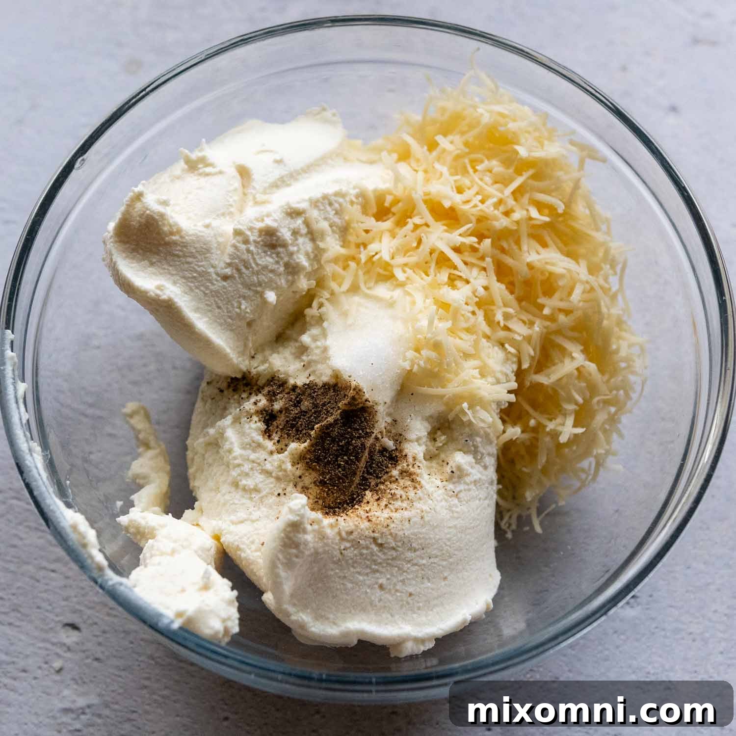 ingredients for ricotta sauce in glass bowl.