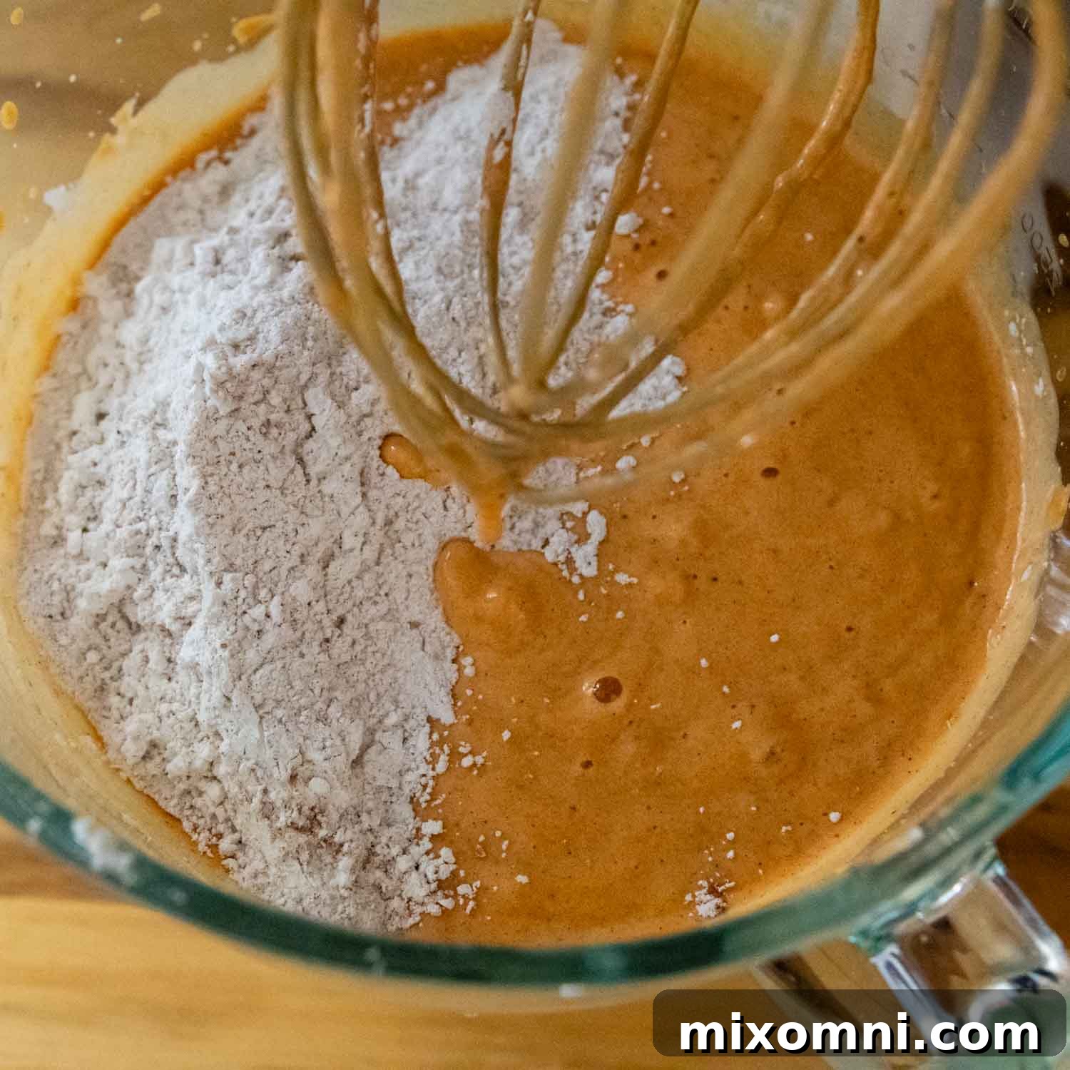 whisking together pumpkin puree and dry ingredients.