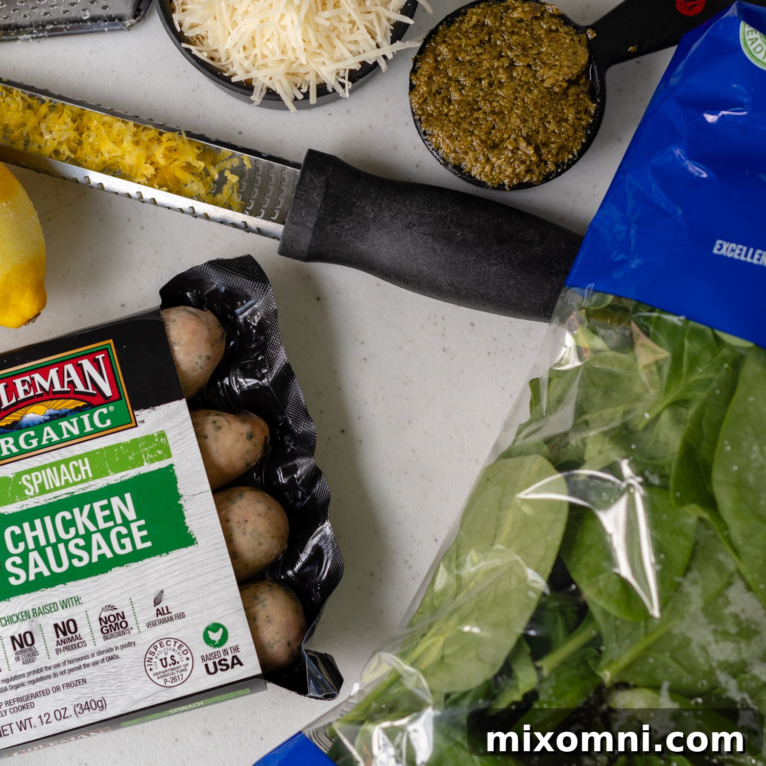 Ingredients for creamy chicken sausage pasta, neatly prepped and laid out on a counter.