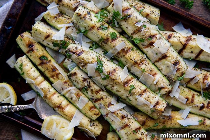 overhead shot of grilled zucchini on a baking sheet.