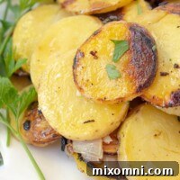 A close-up of perfectly grilled potato and onion slices, garnished with fresh parsley, served on a white plate, highlighting their creamy texture and golden finish.