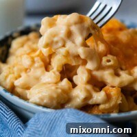 Gluten-Free Mac and Cheese being lifted out of a bowl by a fork.