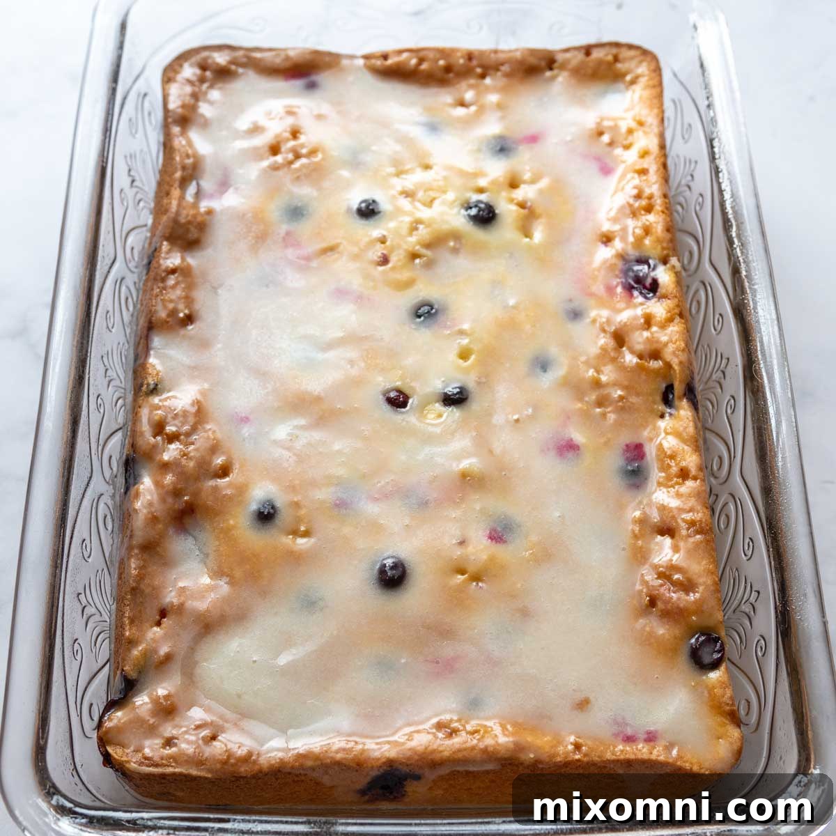 lemon glaze spread on baked cake.