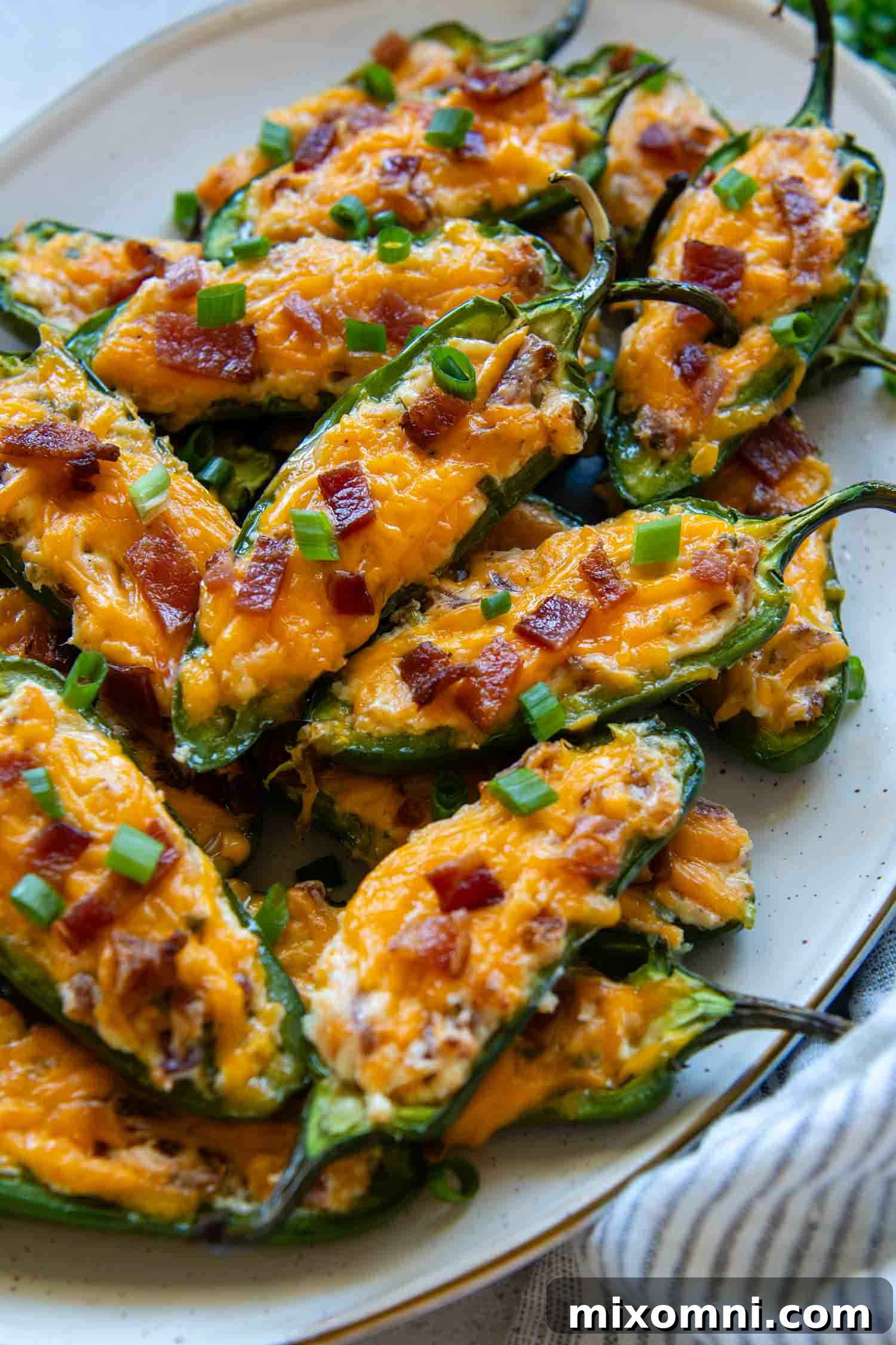 A serving platter brimming with freshly baked jalapeño poppers, ready to be enjoyed as a delicious appetizer.