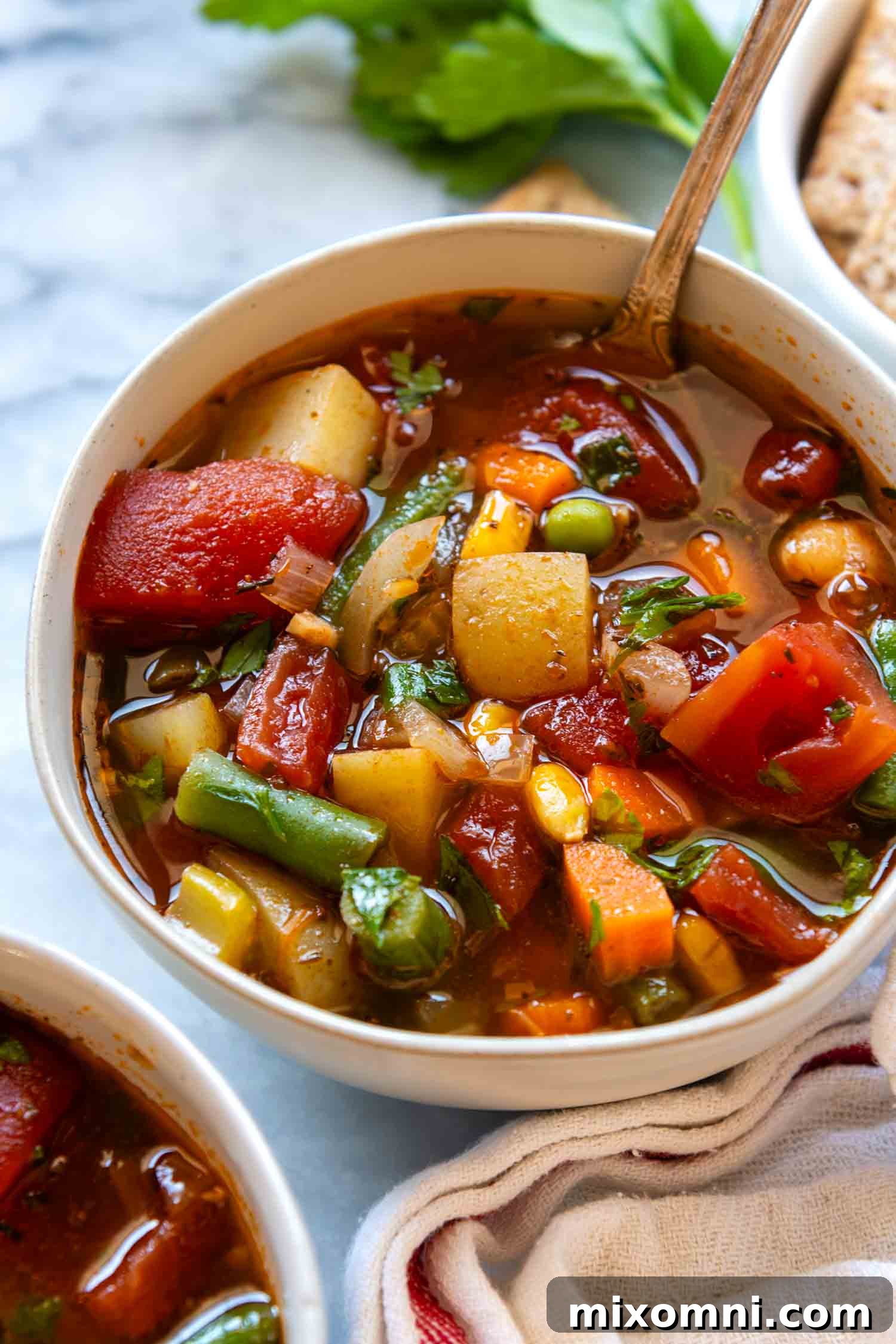 Hearty Gluten-Free Vegetable Soup served in a white bowl, garnished with fresh herbs.