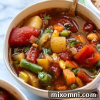 Gluten-Free Vegetable Soup ready to eat in a white bowl.