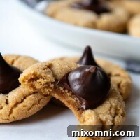 Close up of the texture of the inside of a gluten-free peanut butter blossom cookie, showing its soft and chewy center.