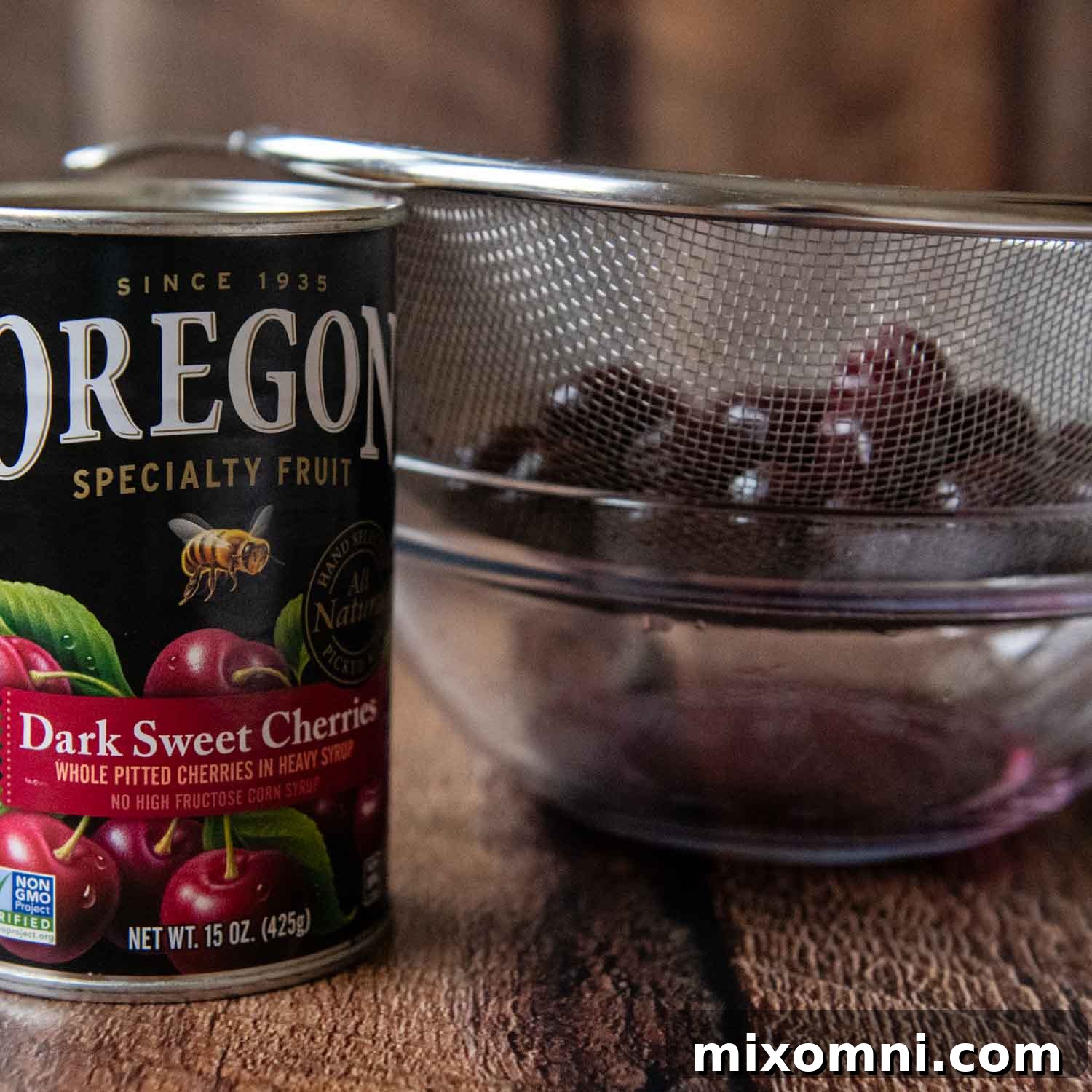 Ingredients for the cherry topping, including drained cherries and Kirsch liqueur, prepared for simmering.