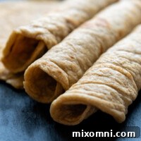 Three Oat Flour Tortillas rolled next to each other.