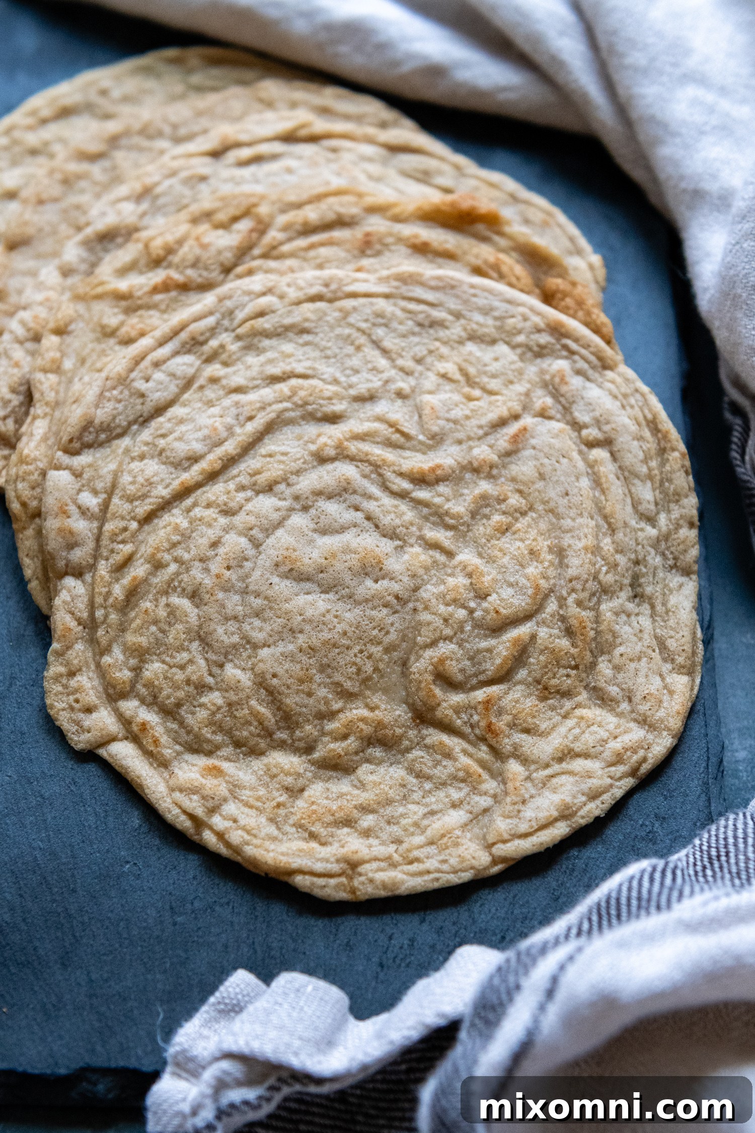 A perfectly cooked stack of soft and flexible oat flour tortillas, ready to be filled and enjoyed.
