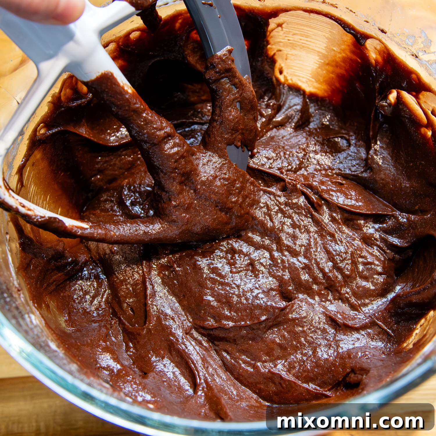 Thick cake ingredients after further mixing, showing a more spreadable consistency.