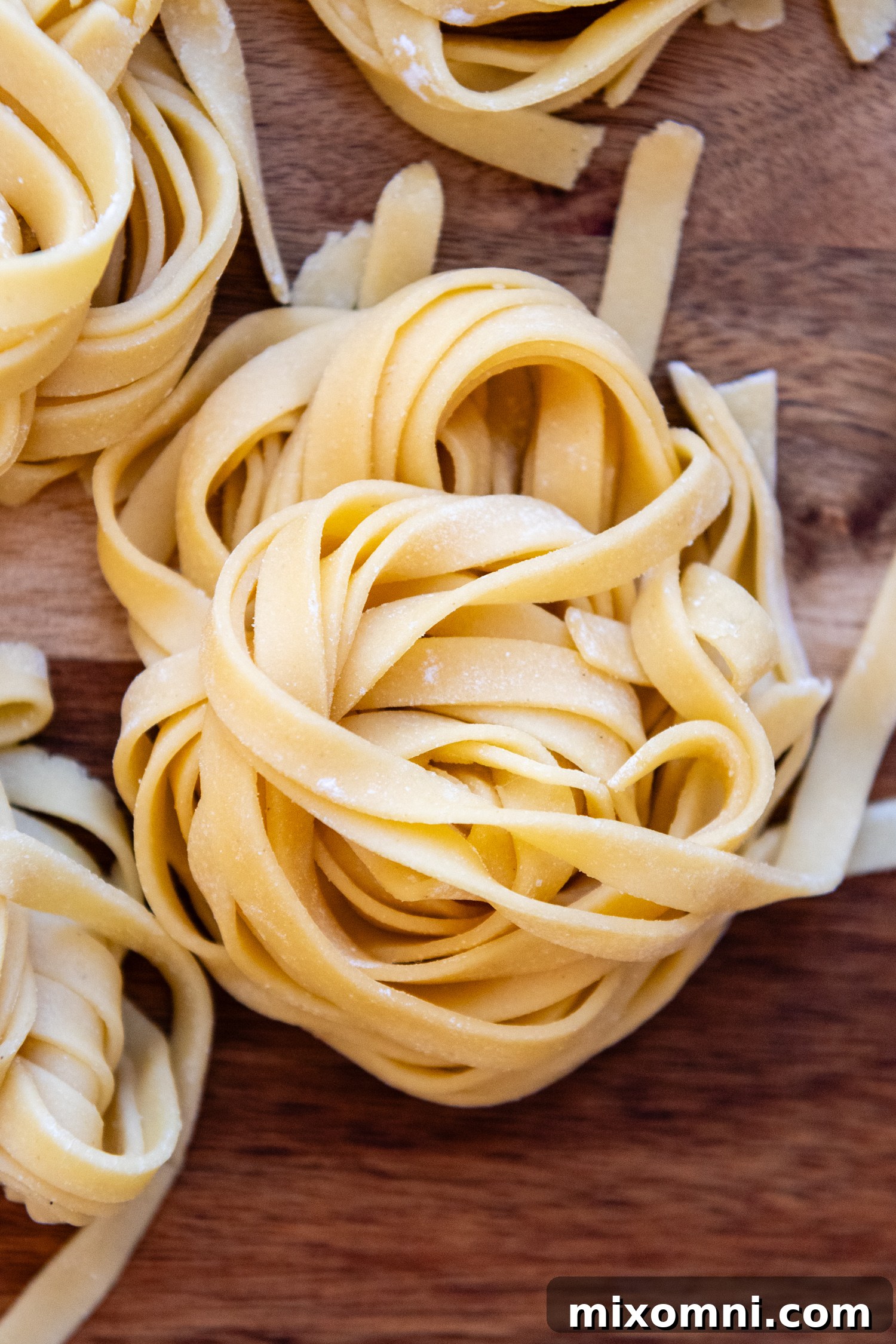 Close-up view of beautifully folded ribbons of fresh gluten-free pasta, showcasing its tender texture.