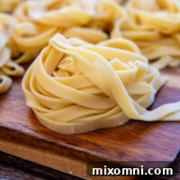 Gluten-Free Pasta folded into nests and stacked on a cutting board, ready to cook.