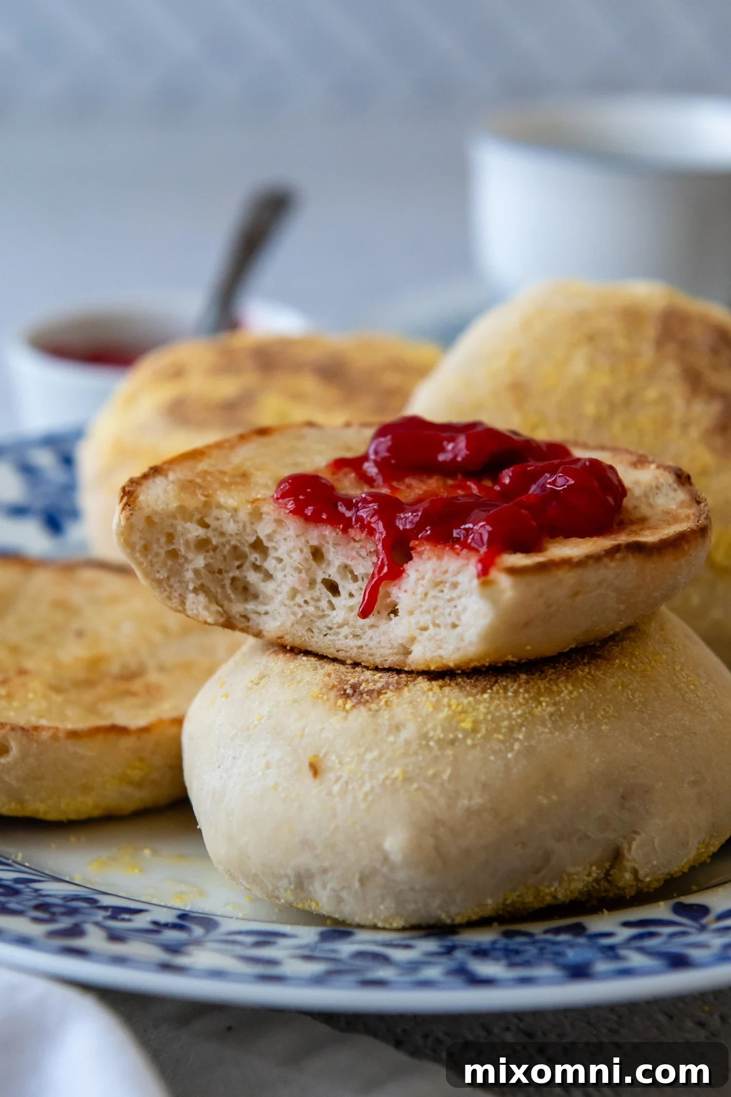 Delicious Gluten-Free English Muffin topped with sweet preserves, showcasing its soft, airy texture and signature nooks and crannies.