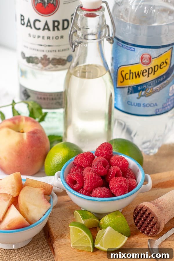 all the makings laid out to make a raspberry peach mojito
