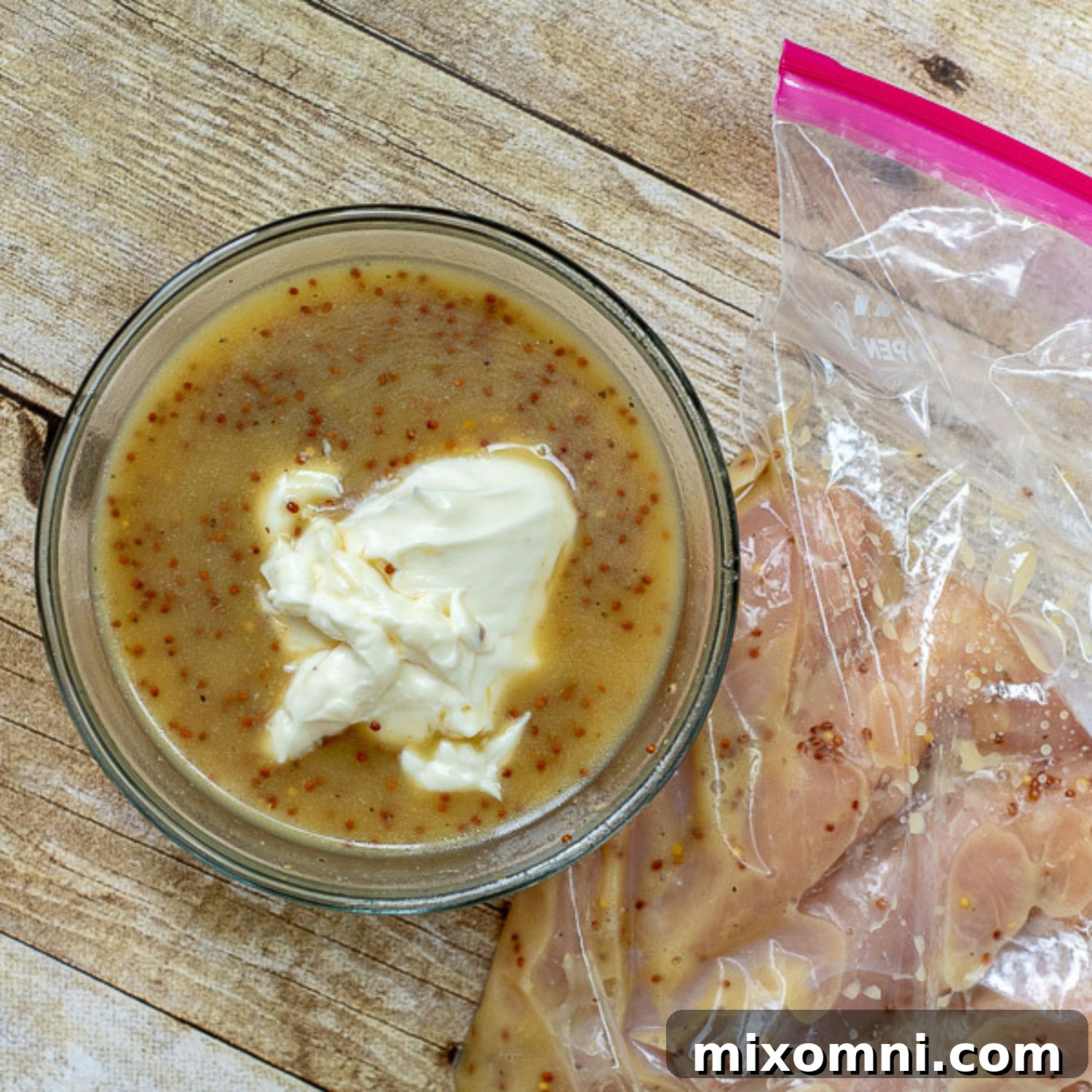 Ingredients for honey mustard marinade and dressing, showcasing oil, honey, and mustards in bowls.