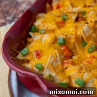 A close-up of Mexican chicken casserole with melted cheese on top, ready to be served.