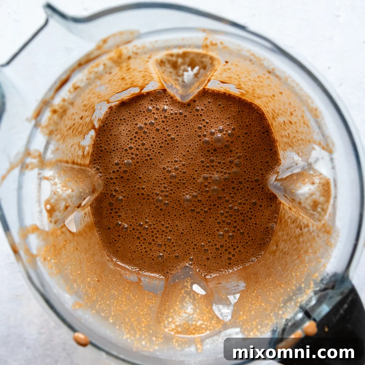 All cake ingredients for the oat flour chocolate cake combined in a blender, ready to be blended into a smooth batter.