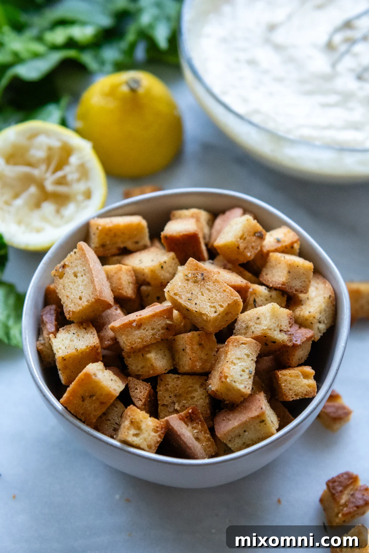 A bowl filled with perfectly golden, seasoned homemade gluten-free croutons.