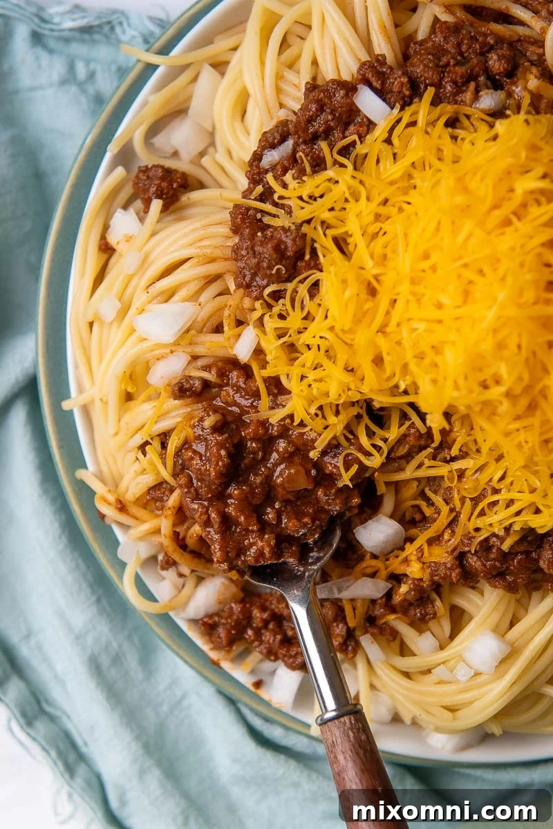overhead shot of cincinnati chili with a fork going into spaghetti