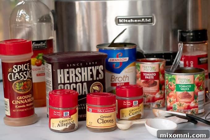 all the ingredients to make Cincinnati Chili laid out in front of slow cooker.