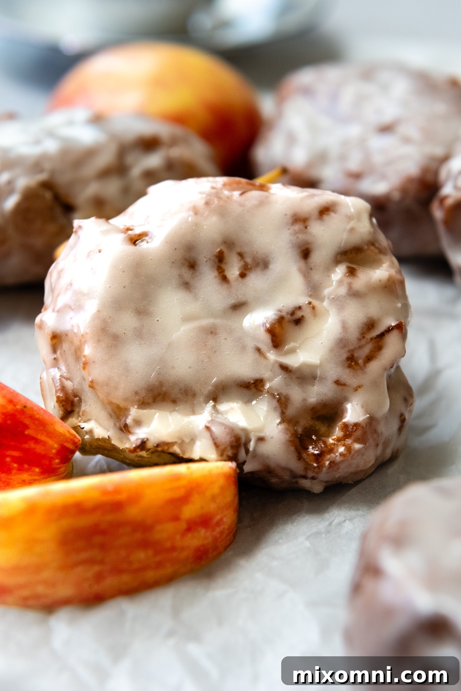 Apple fritter close up with a slice of apple.