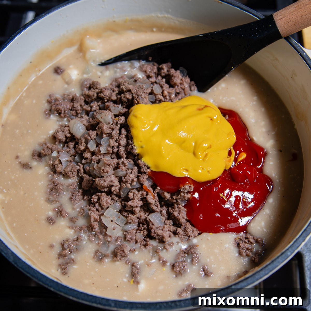Black spoon mixing ingredients for soup together.