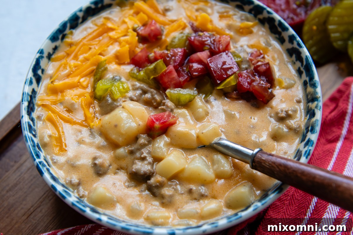 Overhead shot of soup with toppings in a bowl with a spoon.