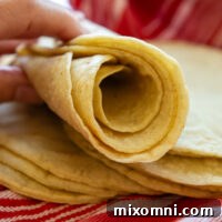 Rolled up stack of gluten free corn tortillas, perfect for any Mexican dish.