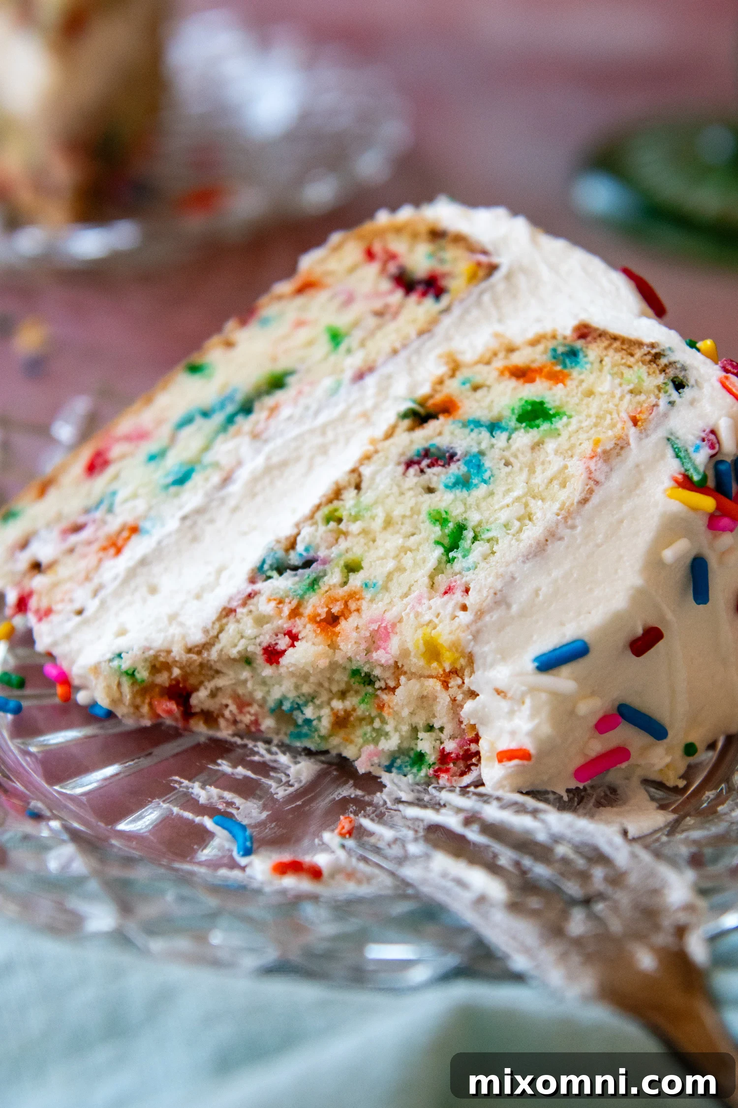 A vibrant gluten-free funfetti cake, fluffy and dotted with rainbow sprinkles, ready for any celebration.