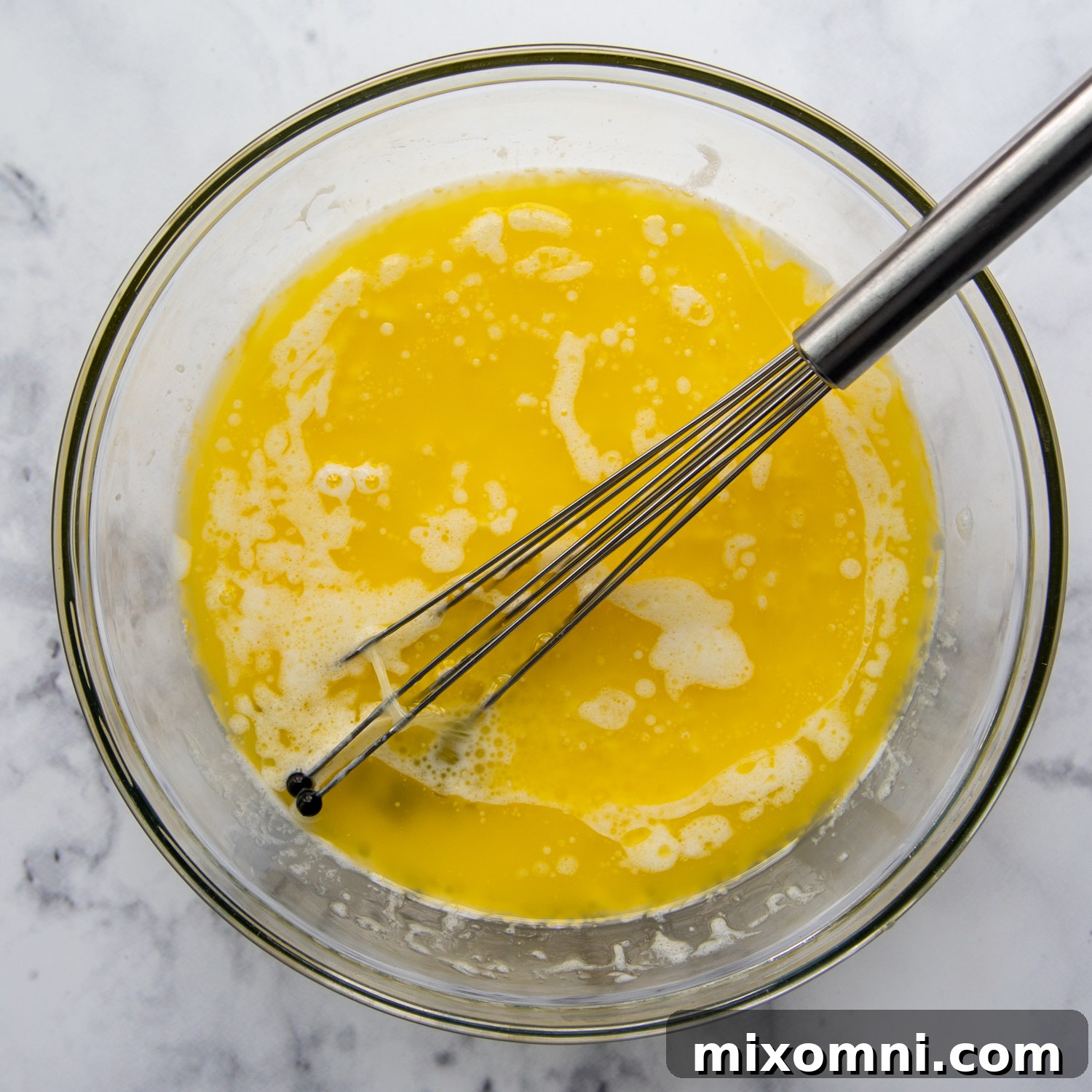 Glass bowl of melted butter.
