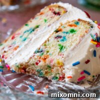 A beautiful slice of Gluten-Free Birthday cake on a glass plate.